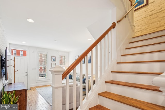 staircase with hardwood / wood-style flooring