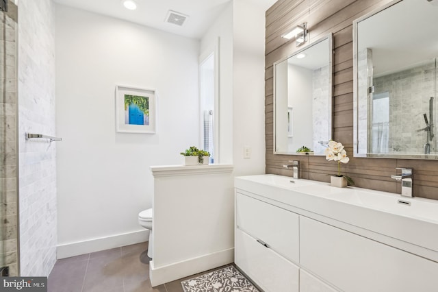 bathroom with tile patterned flooring, vanity, toilet, and a shower with shower door