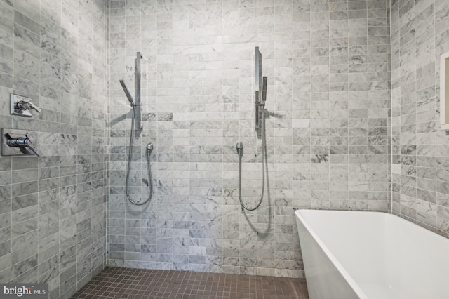 bathroom featuring shower with separate bathtub