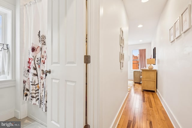 corridor with light hardwood / wood-style floors