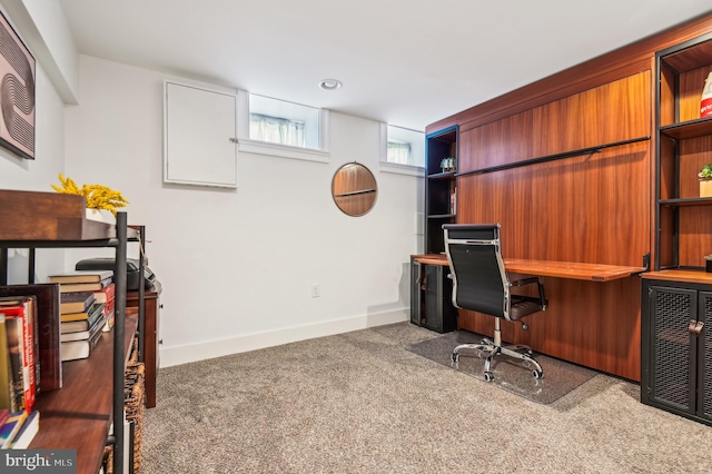 carpeted office featuring built in desk and heating unit