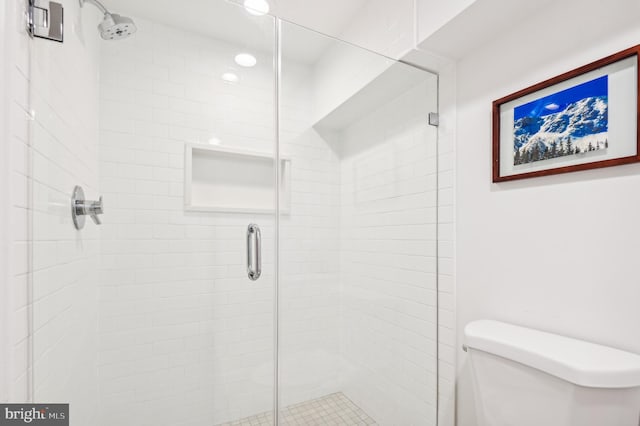 bathroom with toilet and walk in shower