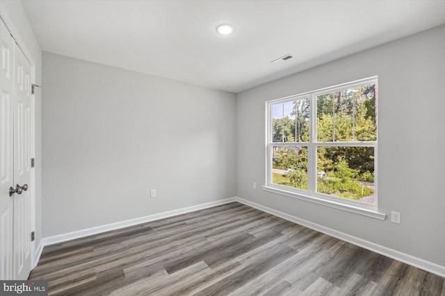 unfurnished room with hardwood / wood-style floors