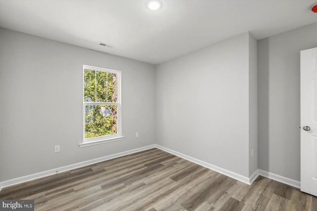 unfurnished room with hardwood / wood-style floors