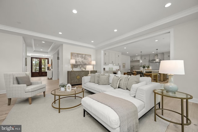 living room with french doors, light hardwood / wood-style floors, and crown molding