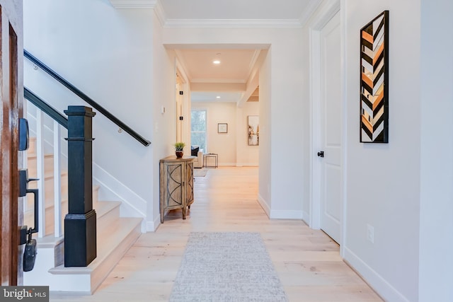 hall with wood finished floors, stairway, crown molding, and baseboards
