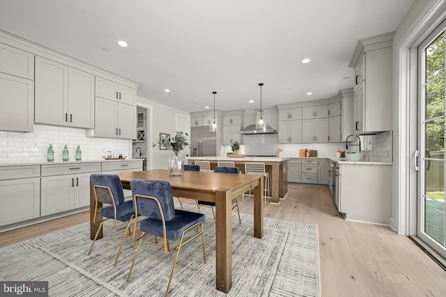 dining area featuring light hardwood / wood-style floors and sink