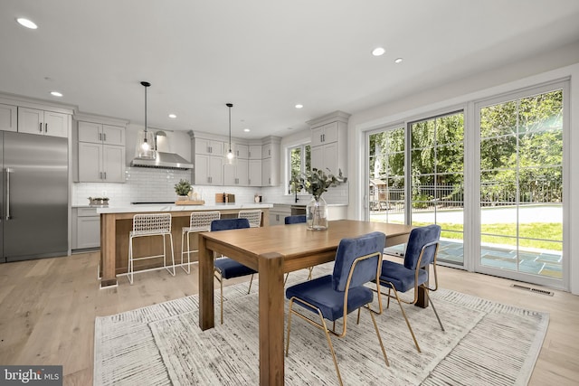 dining area featuring a wealth of natural light and light hardwood / wood-style flooring