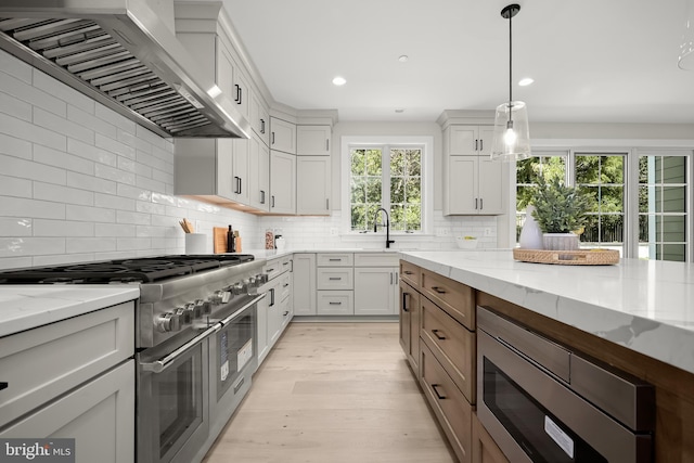 kitchen featuring stainless steel appliances, light stone countertops, and white cabinets