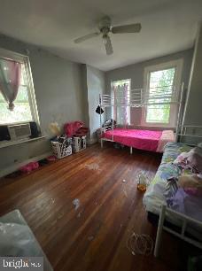 bedroom featuring wood-type flooring and ceiling fan