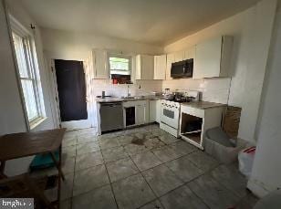 kitchen with stainless steel dishwasher, white cabinetry, and white gas range oven