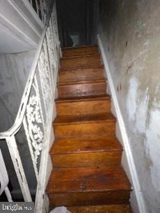 staircase with hardwood / wood-style floors