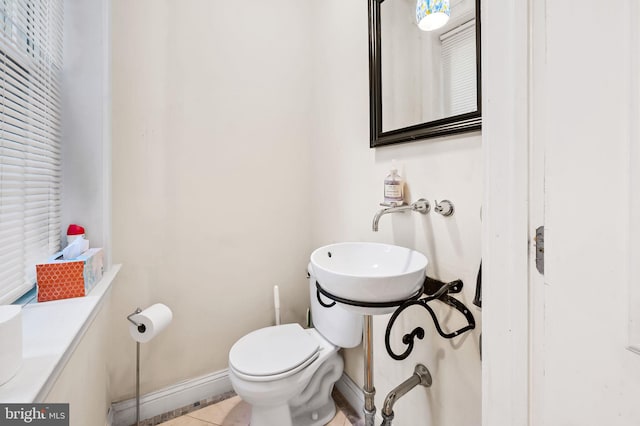 bathroom featuring toilet and tile patterned floors