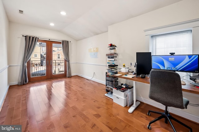 home office featuring french doors, light hardwood / wood-style floors, and lofted ceiling