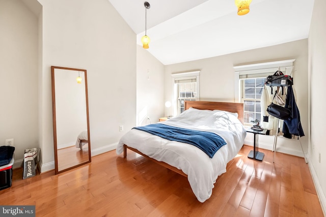 bedroom with wood-type flooring and lofted ceiling