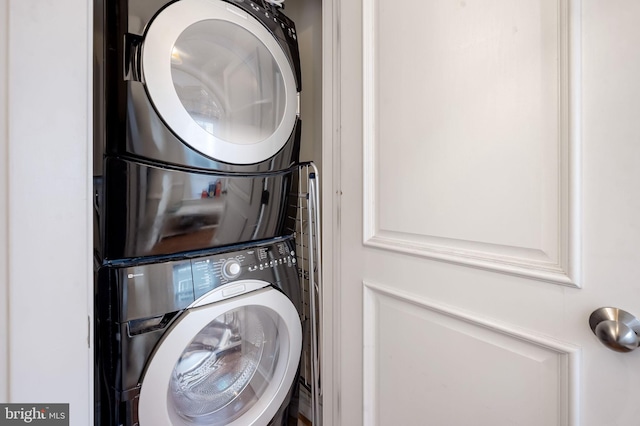 clothes washing area with stacked washer / dryer