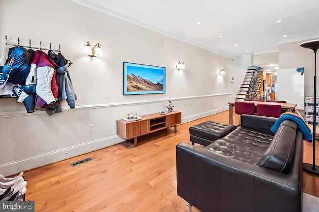 living room with ornamental molding and hardwood / wood-style flooring