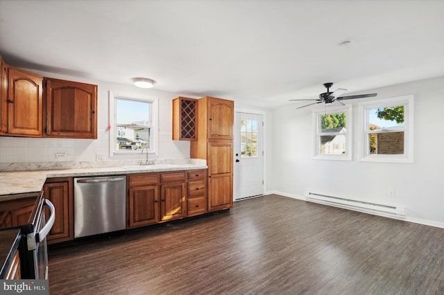 kitchen with baseboard heating, plenty of natural light, sink, and appliances with stainless steel finishes