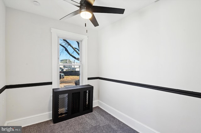 sitting room featuring ceiling fan and dark carpet