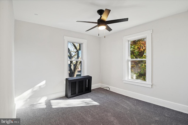 empty room with ceiling fan, a healthy amount of sunlight, and carpet flooring