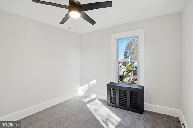 empty room with ceiling fan and carpet flooring