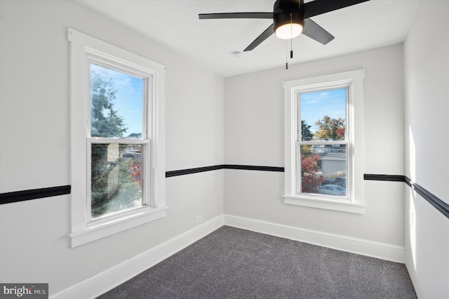 carpeted spare room featuring ceiling fan