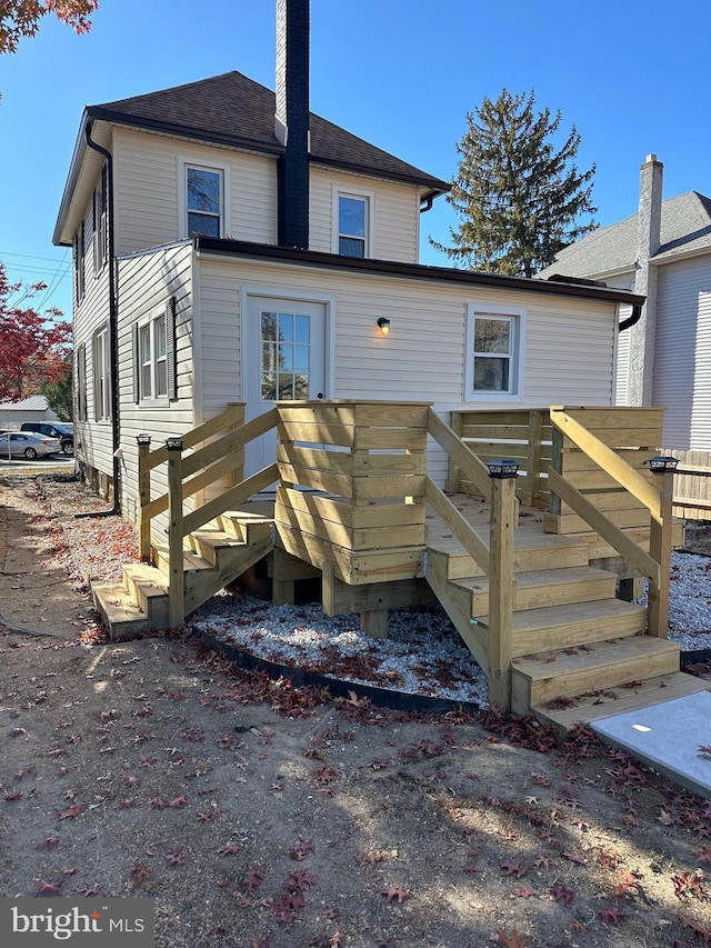 rear view of property featuring a deck