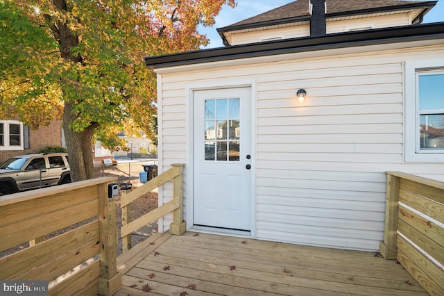 view of exterior entry featuring a deck