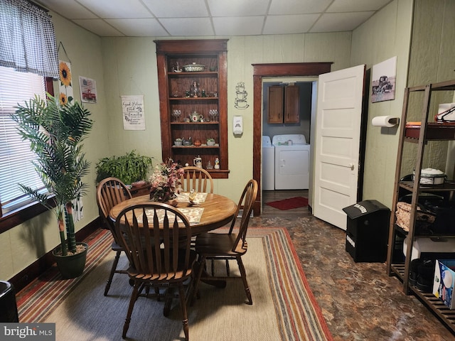 dining room with washer and clothes dryer and a paneled ceiling