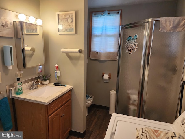 bathroom with wood-type flooring, vanity, toilet, and walk in shower