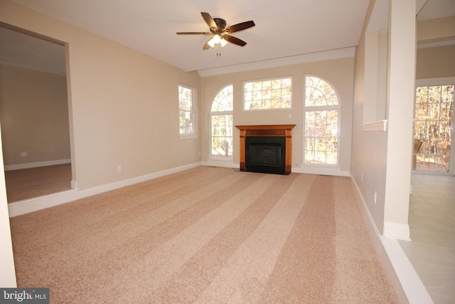 unfurnished living room featuring light colored carpet and ceiling fan