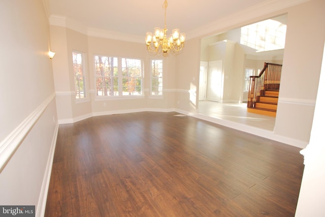 unfurnished room featuring crown molding, dark hardwood / wood-style flooring, and a notable chandelier