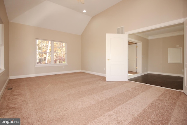 unfurnished room with carpet flooring, lofted ceiling, and ornamental molding