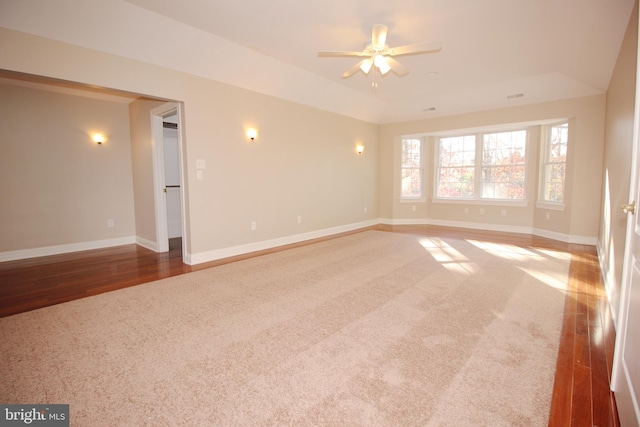 spare room featuring ceiling fan, vaulted ceiling, and hardwood / wood-style flooring