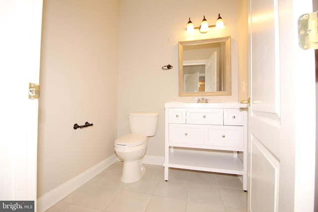 bathroom with tile patterned floors, vanity, and toilet