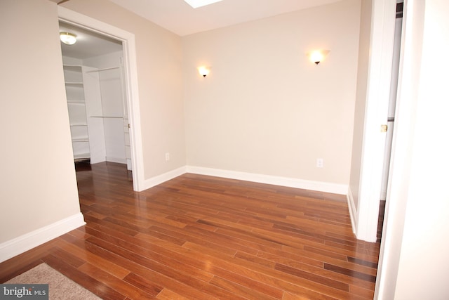 unfurnished room featuring dark wood-type flooring