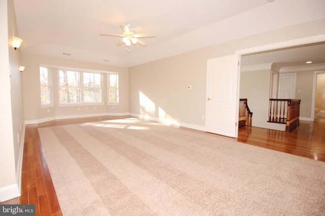 unfurnished room featuring hardwood / wood-style flooring, a raised ceiling, and ceiling fan