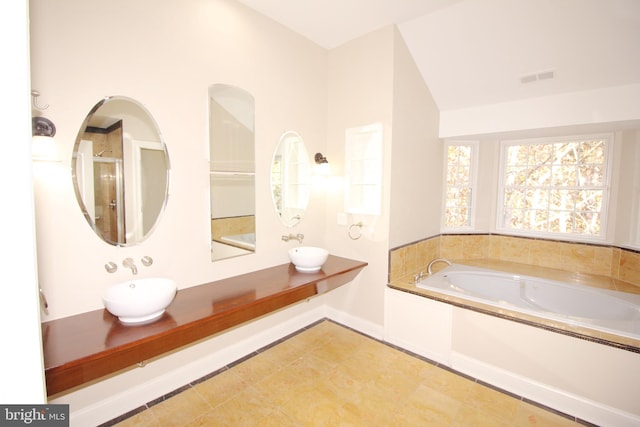 bathroom featuring tile patterned floors, a bathtub, and sink