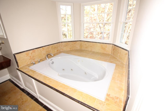 bathroom with a tub to relax in and tile patterned flooring