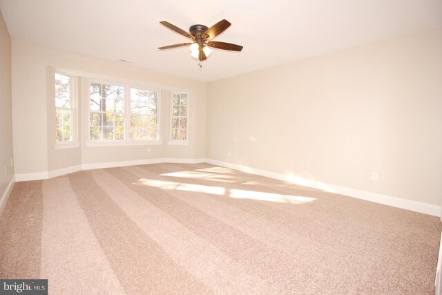 unfurnished room featuring carpet flooring and ceiling fan