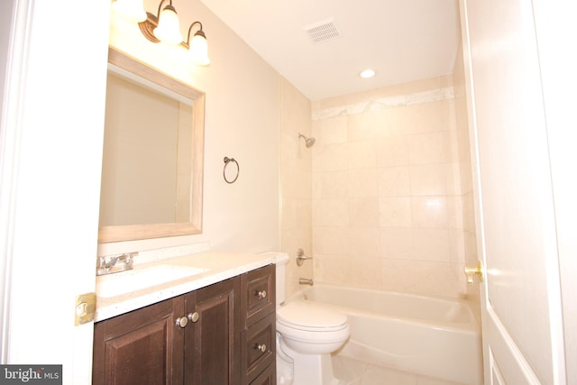 full bathroom featuring tile patterned floors, vanity, toilet, and tiled shower / bath