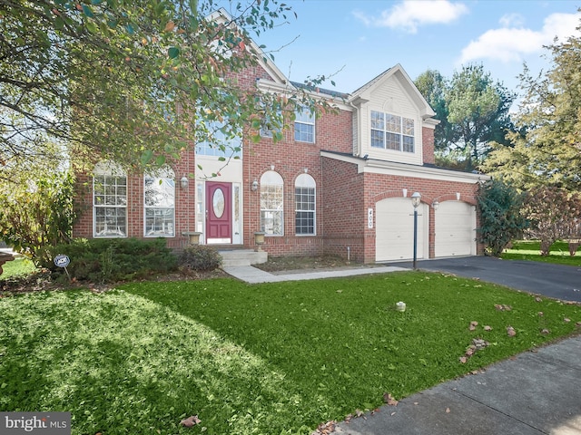 view of front of property with a garage and a front lawn