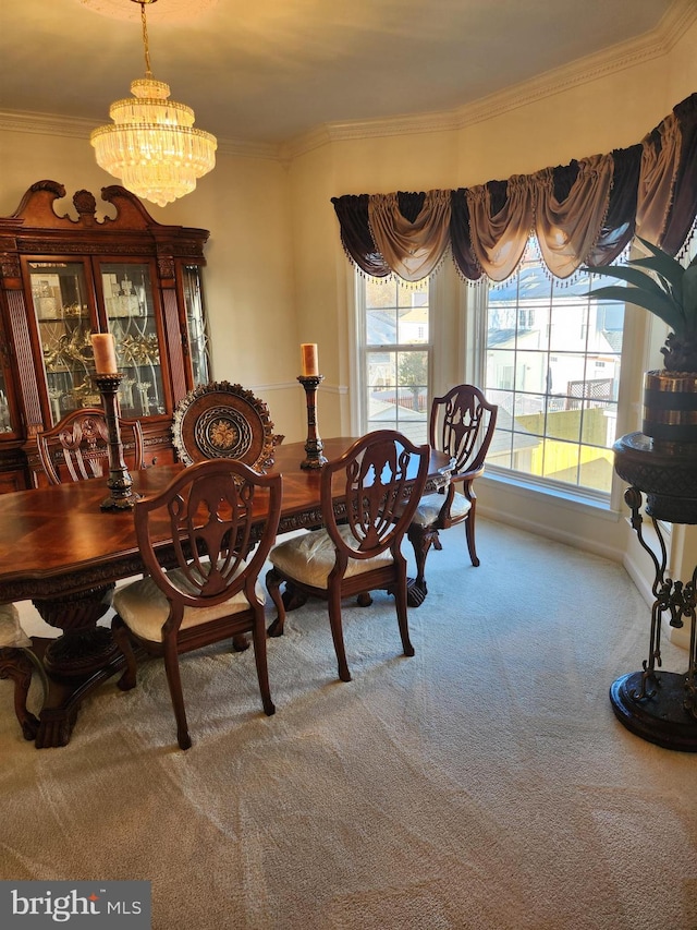 dining area featuring carpet flooring, crown molding, and a notable chandelier