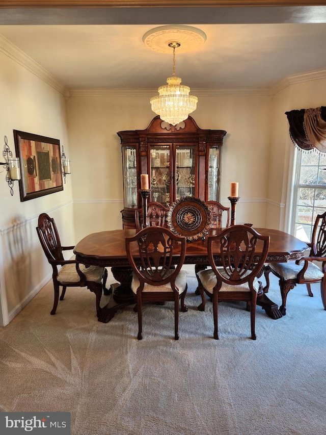 carpeted dining area with a notable chandelier and crown molding