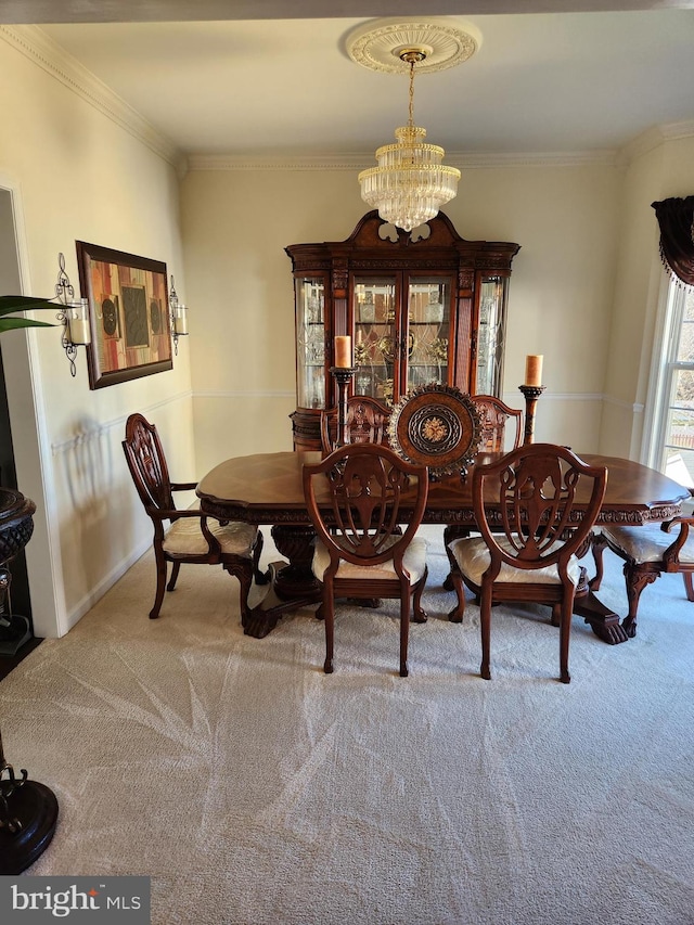 dining area with light carpet, crown molding, and an inviting chandelier