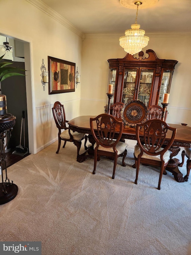 carpeted dining space with an inviting chandelier and ornamental molding