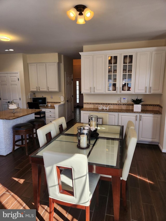 dining room with dark hardwood / wood-style floors