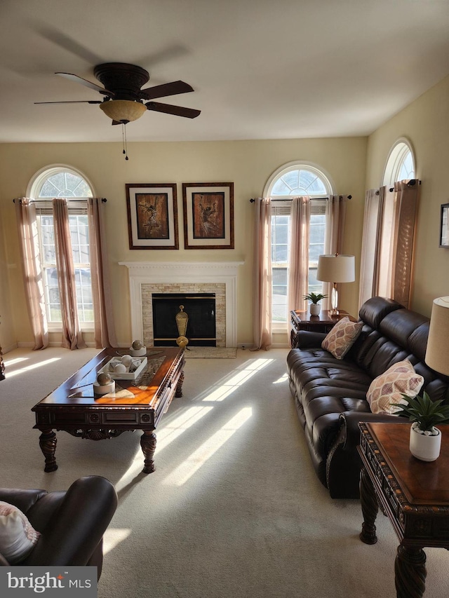 carpeted living room featuring plenty of natural light and ceiling fan