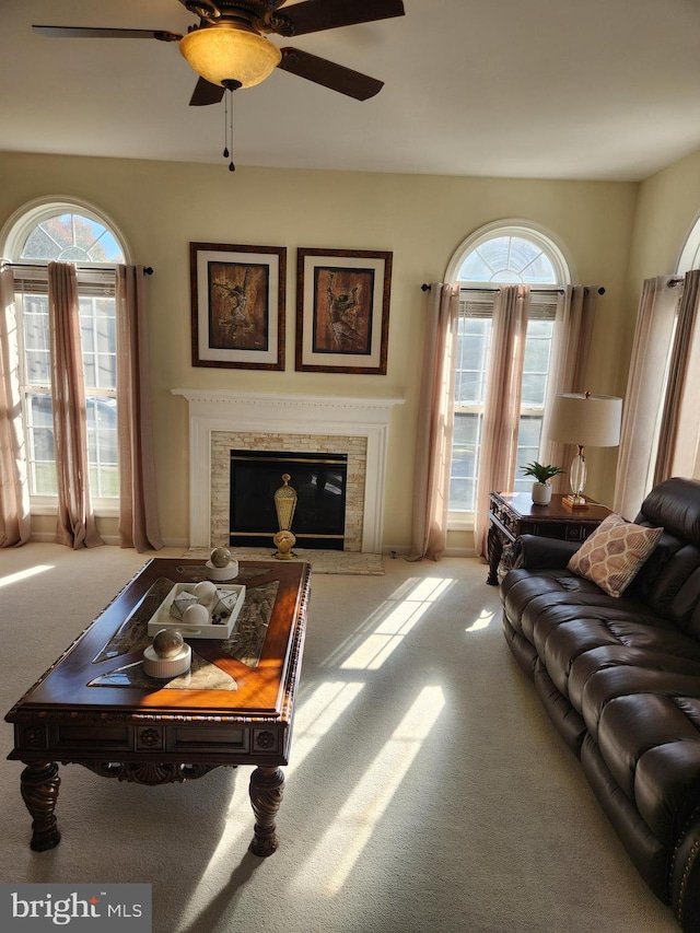 carpeted living room featuring a wealth of natural light and ceiling fan