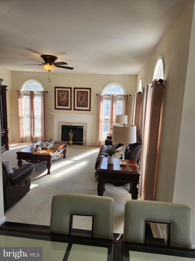 carpeted living room with ceiling fan and a healthy amount of sunlight